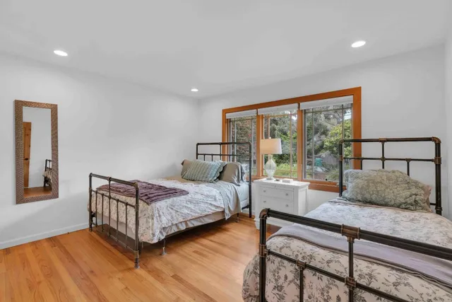 a bedroom with a bed and large window