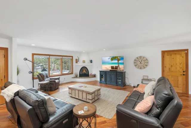 a living room with furniture a table and a large window
