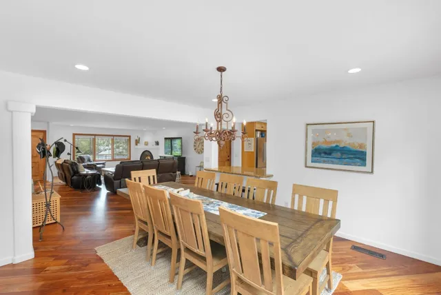 a view of a a dining room with furniture window and wooden floor