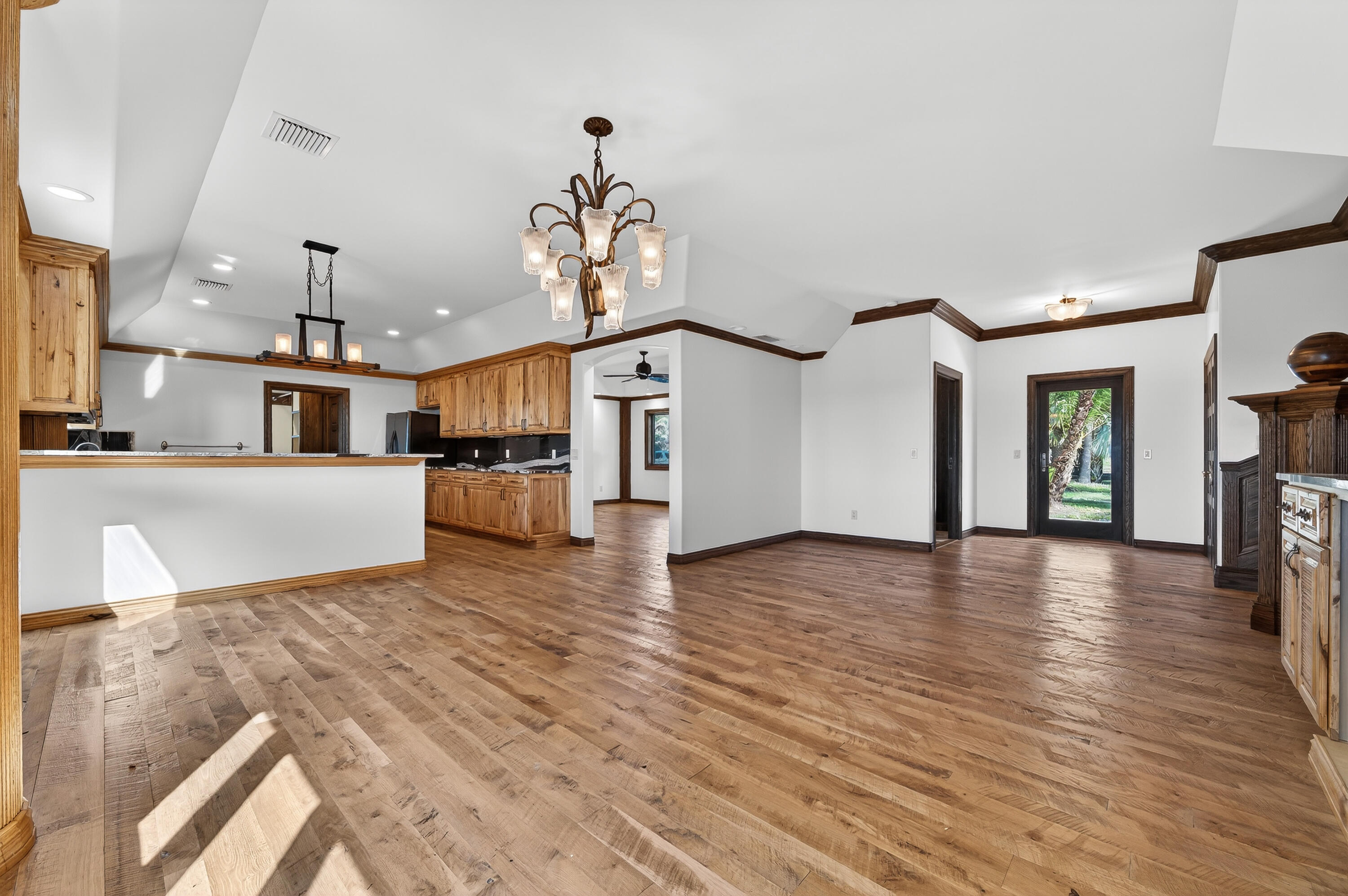 200 South Graves Road Fort Pierce, FL 34945 - Photo 15 of 58 a view of a living room and kitchen with furniture wooden floor and a kitchen