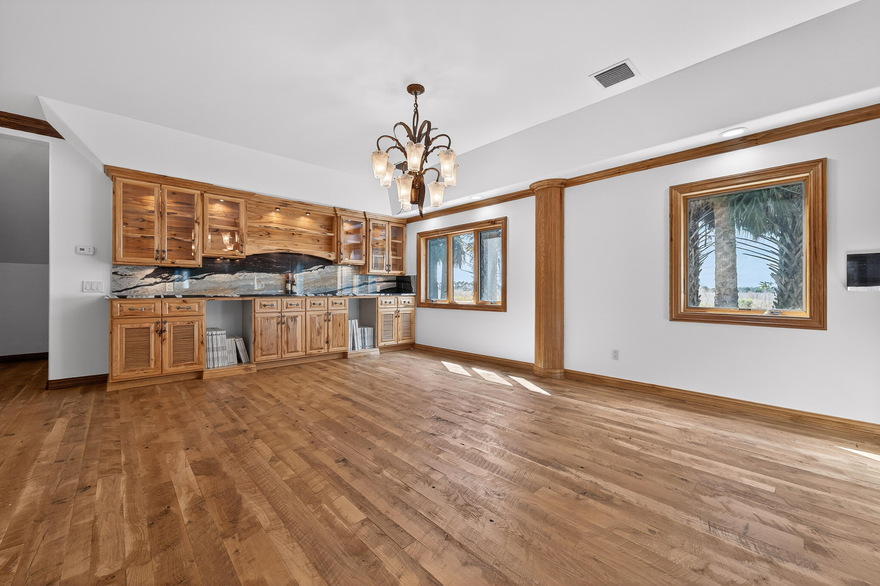 200 South Graves Road Fort Pierce, FL 34945 - Photo 19 of 58 a view of a kitchen with a stove cabinets and wooden floor