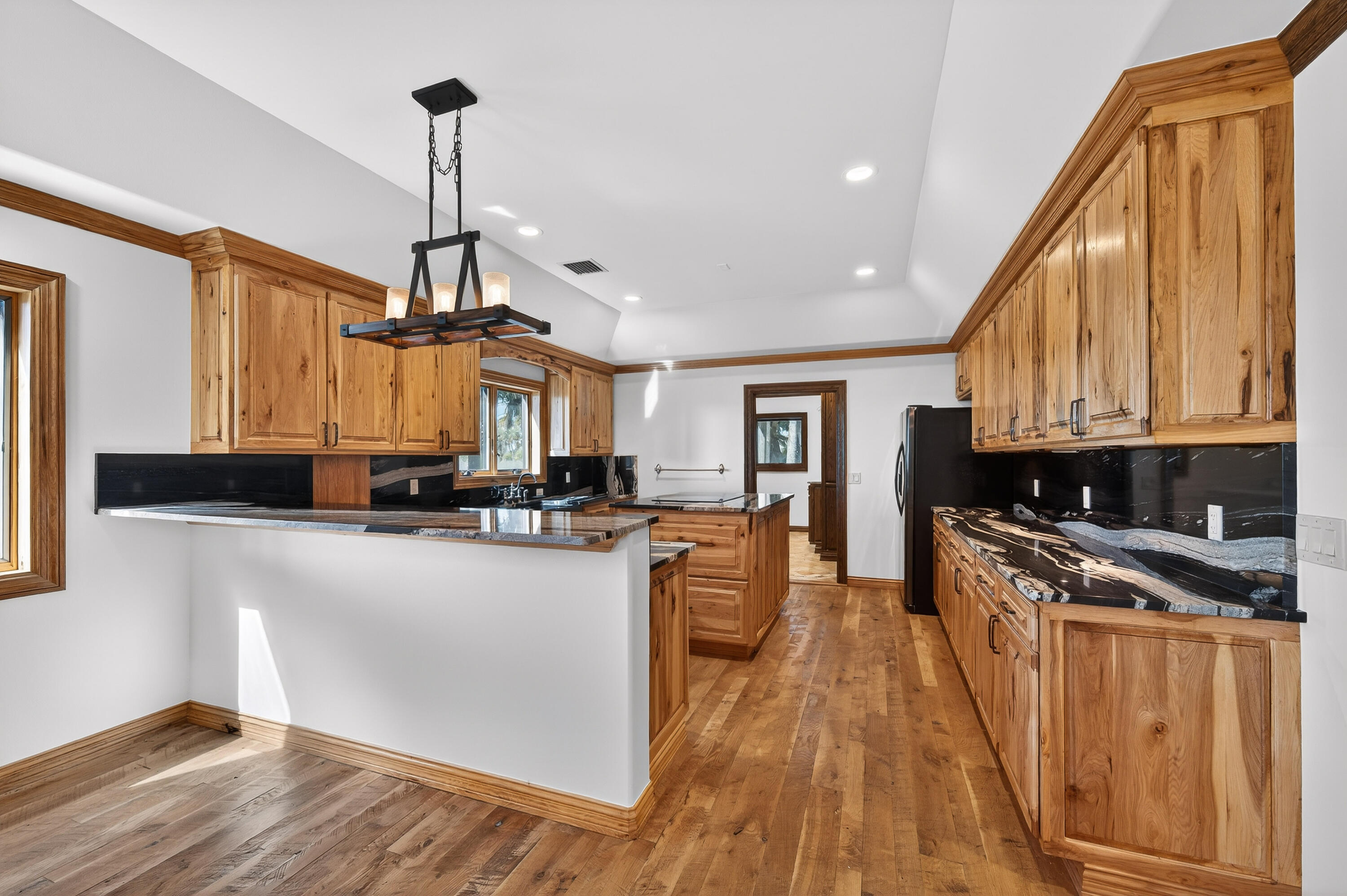 200 South Graves Road Fort Pierce, FL 34945 - Photo 21 of 58 a kitchen with stainless steel appliances granite countertop a sink a stove and a wooden floors
