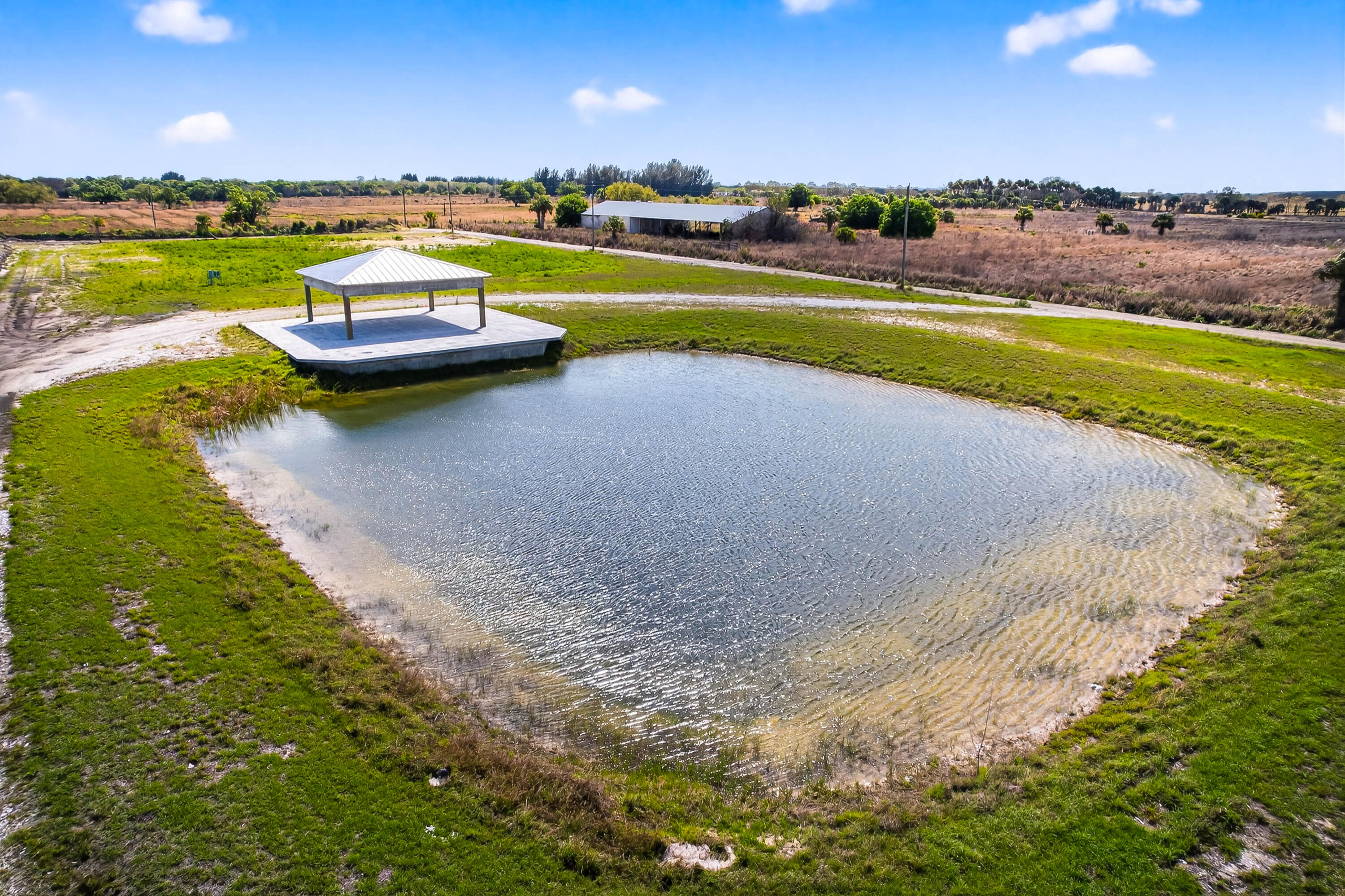 200 South Graves Road Fort Pierce, FL 34945 - Photo 6 of 58 a view of a lake with houses in the back