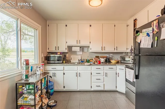 a kitchen with stainless steel appliances a stove a sink and a refrigerator