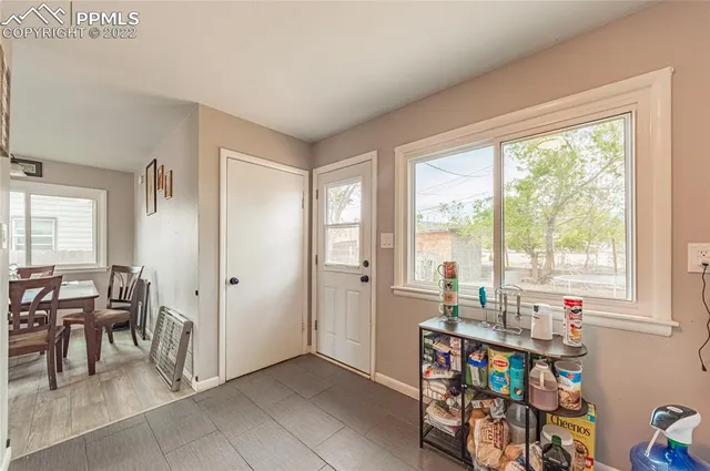 a very nice looking room with a large window and dining table