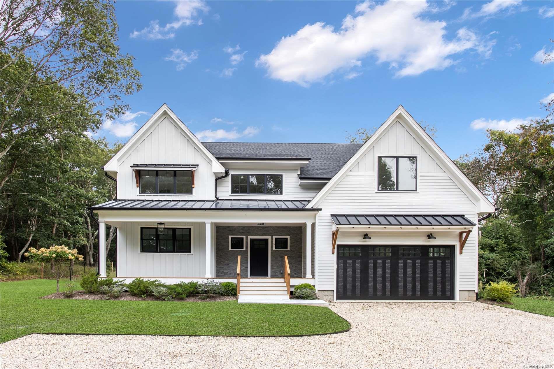 6 Behringer Lane Shelter Island, NY 11964 - Photo 1 of 1 a front view of a house with a yard and garage