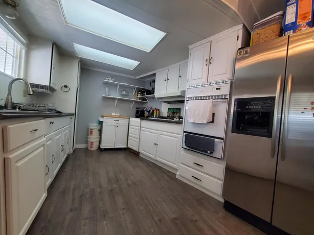 a kitchen with white cabinets and white appliances