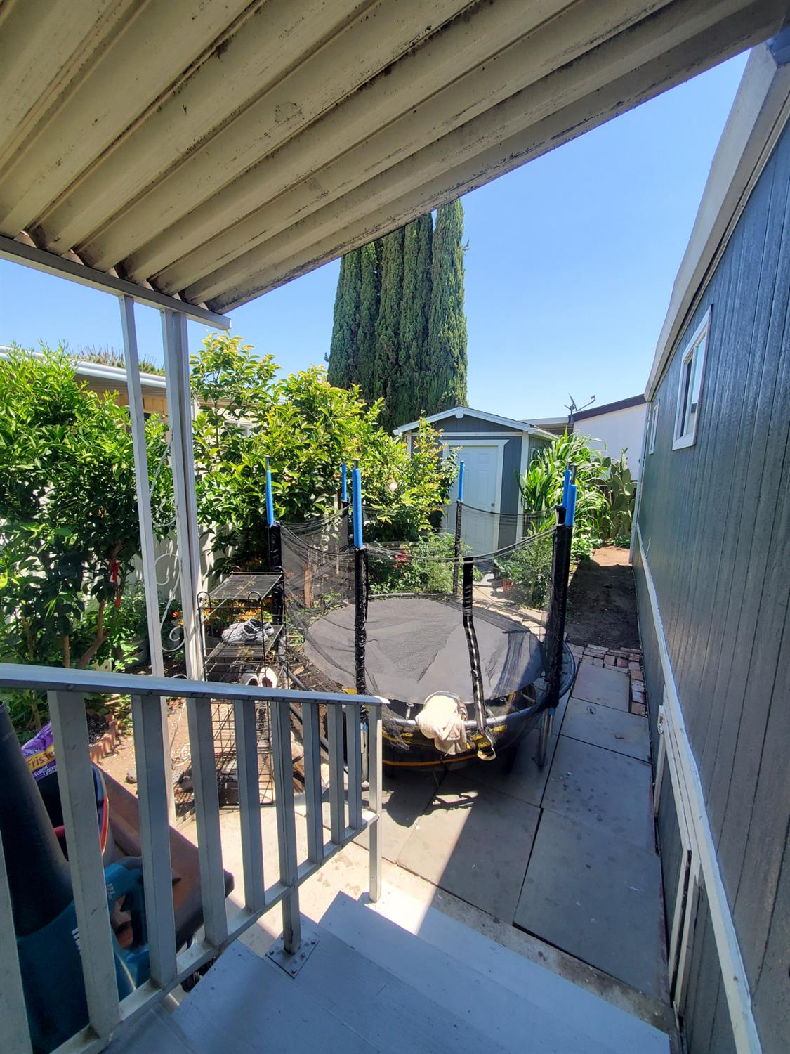 15820 South Harlan Road, Unit 98 Lathrop, CA 95330 - Photo 5 of 25 a view of balcony with chairs and wooden fence