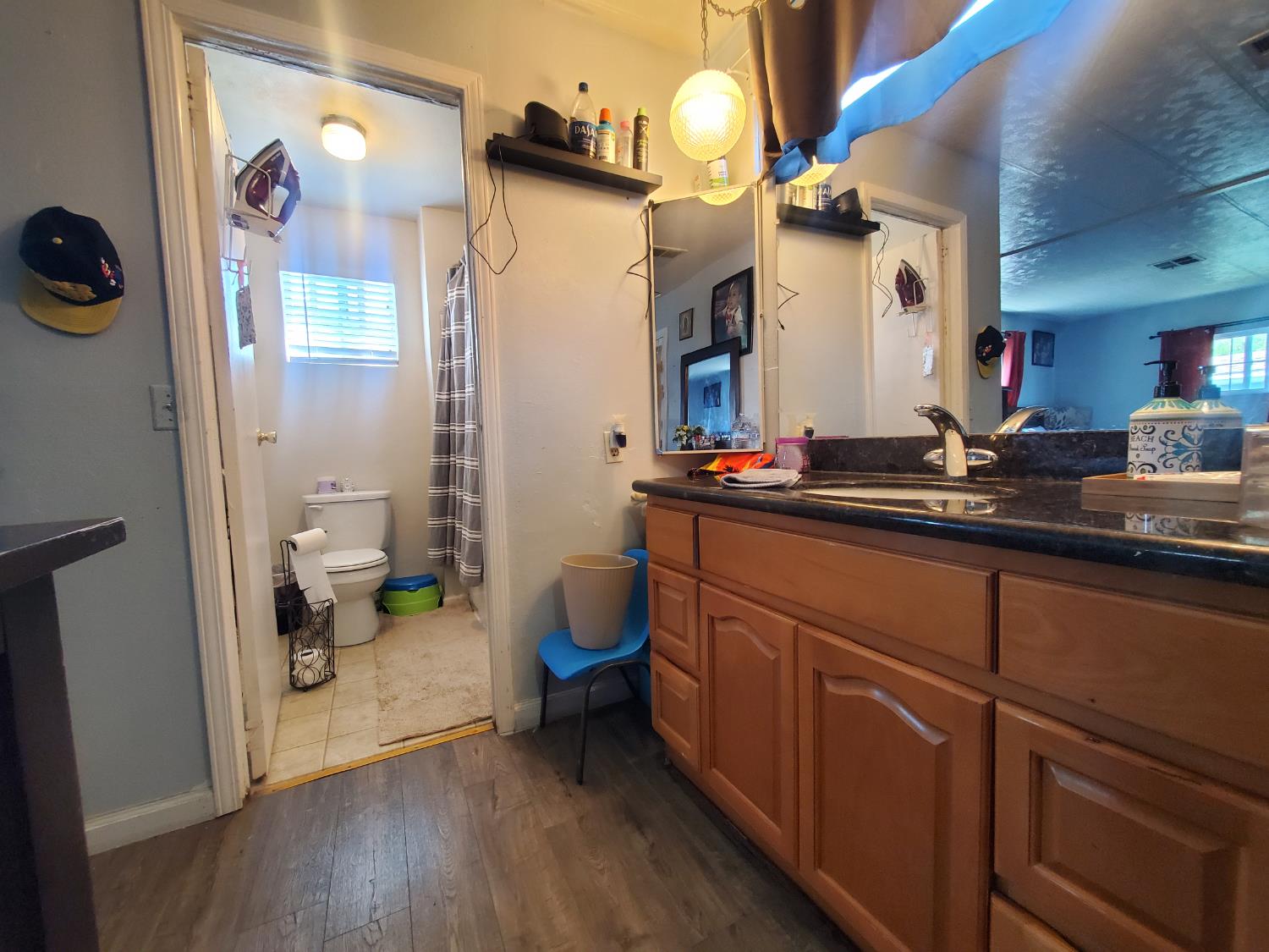 15820 South Harlan Road, Unit 98 Lathrop, CA 95330 - Photo 9 of 25 a bathroom with a sink a toilet and a mirror