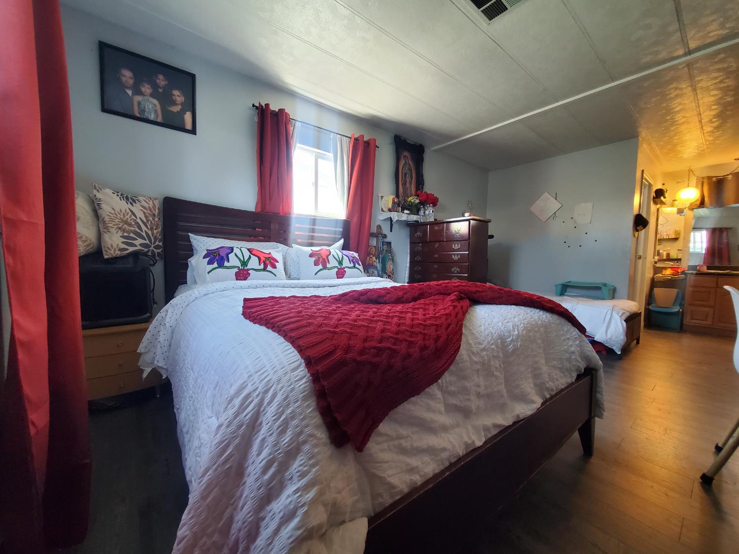 15820 South Harlan Road, Unit 98 Lathrop, CA 95330 - Photo 10 of 25 a bed sitting in a bedroom next to a lamp