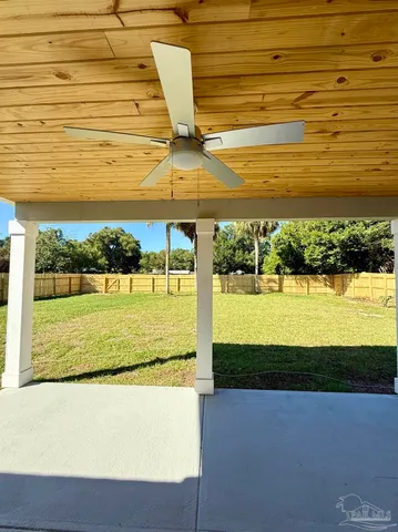 a view of a big yard with wooden fence