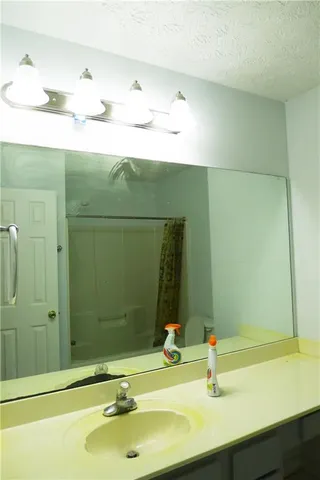 a white toilet sitting next to a bath tub and shower