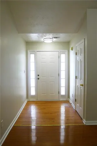 a view of a room with wooden floor