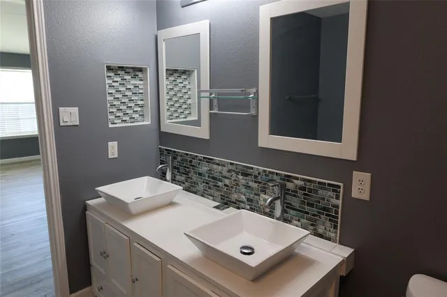 a bathroom with a sink and a mirror