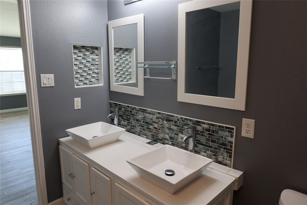 1714 Elm Street Anna, TX 75409 - Photo 12 of 27 a bathroom with a sink and a mirror