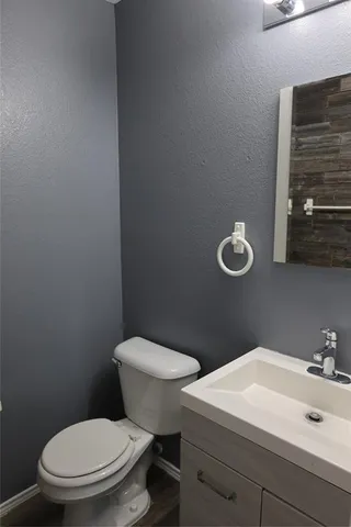 a white toilet sitting next to a bathroom sink