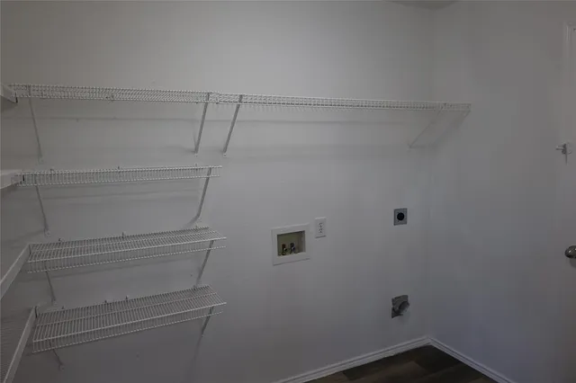 a view of storage and utility room with racks on the wall