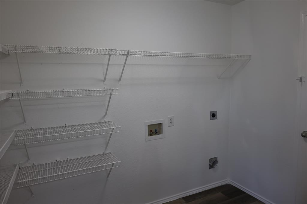 1714 Elm Street Anna, TX 75409 - Photo 23 of 27 a view of storage and utility room with racks on the wall