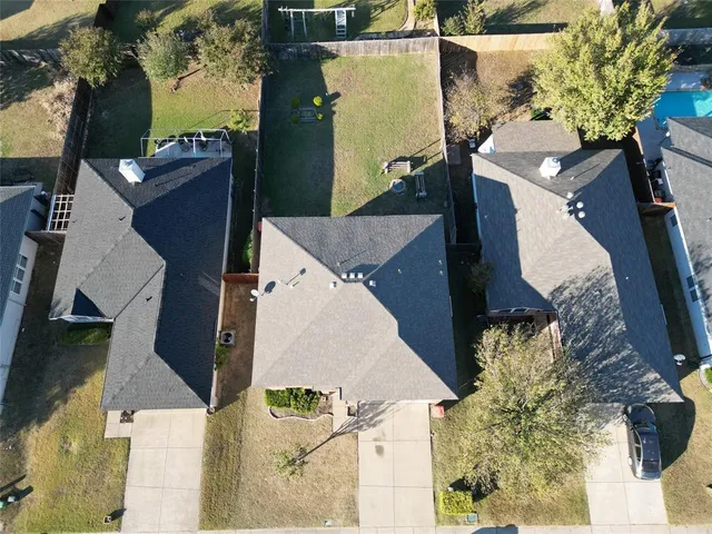 an aerial view of a house with a yard