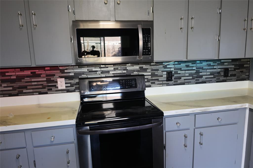 1714 Elm Street Anna, TX 75409 - Photo 5 of 27 a kitchen with a stove and a microwave