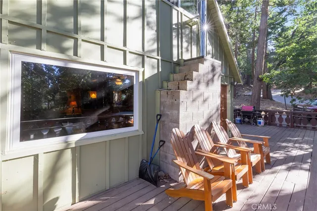 a view of a patio with table and chairs and wooden floor