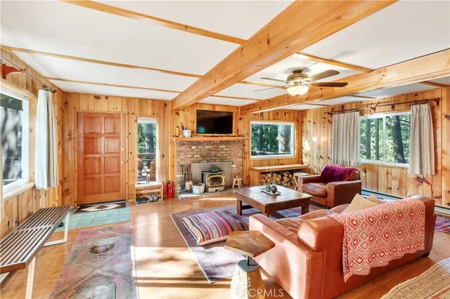 a living room with fireplace furniture and a large window