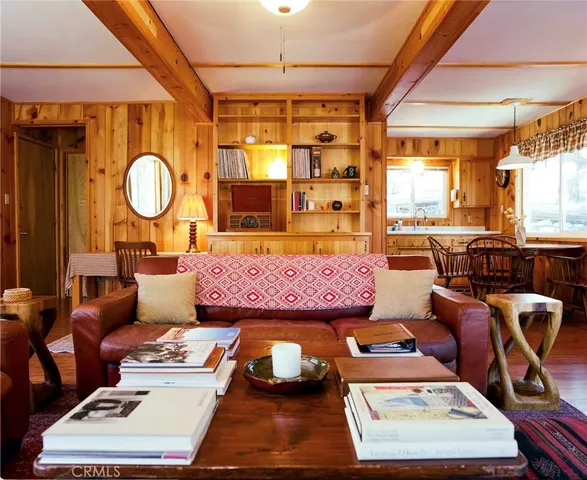 a living room with furniture a table and a large window