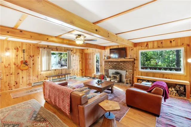 a living room with fireplace furniture and a large window