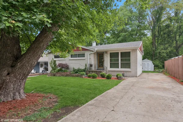 a front view of a house with a yard and porch