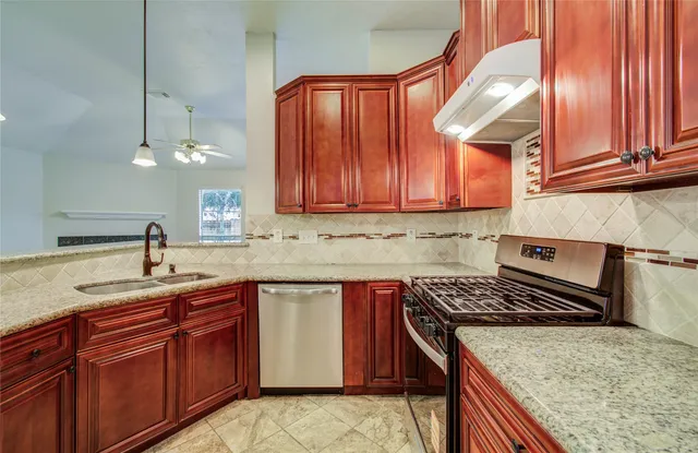 a kitchen with a sink stove and cabinets