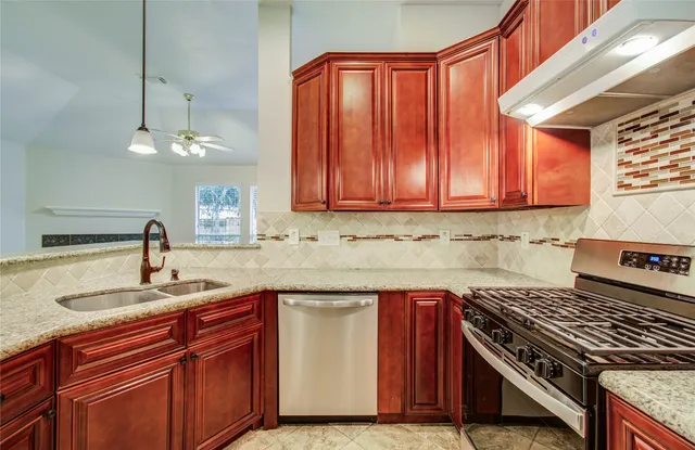 a kitchen with a sink stove and cabinets