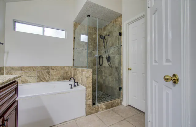 a bathroom with a bathtub and shower