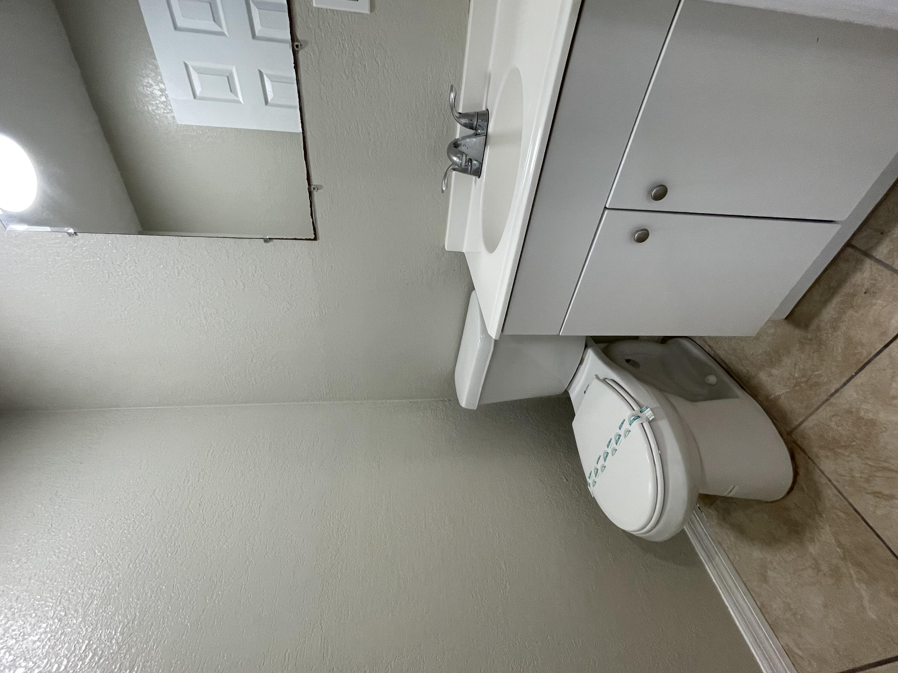 2880 Harson Way Fort Pierce, FL 34946 - Photo 15 of 40 a bathroom with a sink and mirror
