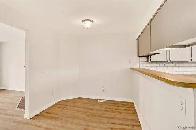 a view of a kitchen with sink and wooden floor