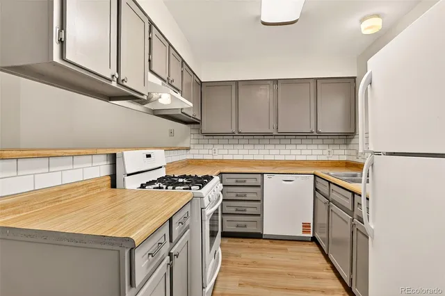 a kitchen with stainless steel appliances granite countertop a sink and cabinets