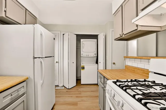 a kitchen with stainless steel appliances granite countertop a refrigerator and a stove