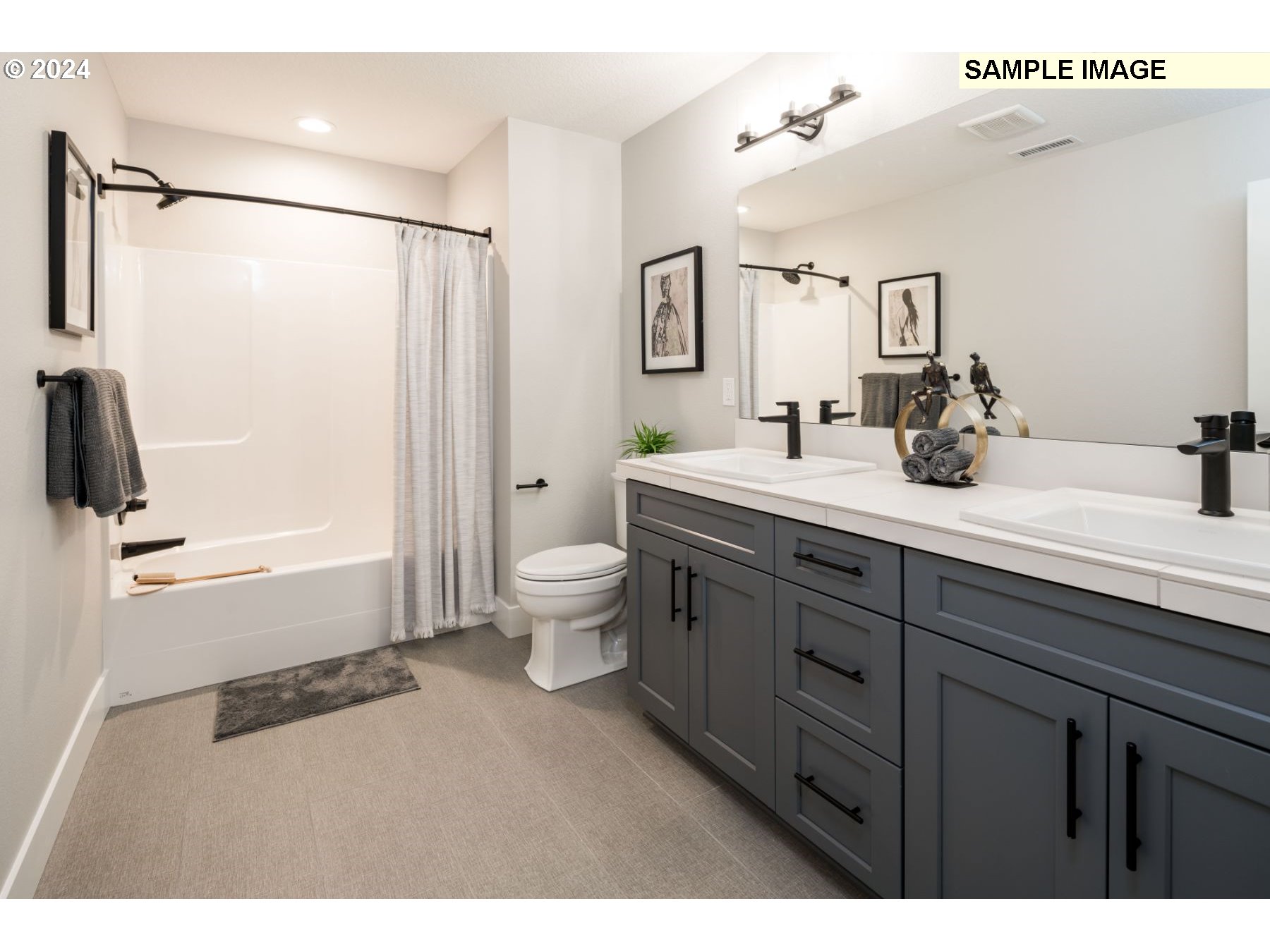 1202 South 46th Place Ridgefield, WA 98642 - Photo 18 of 25 a bathroom with a double vanity sink toilet mirror and shower