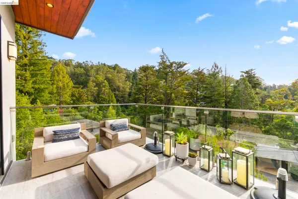 a view of yard from deck with patio
