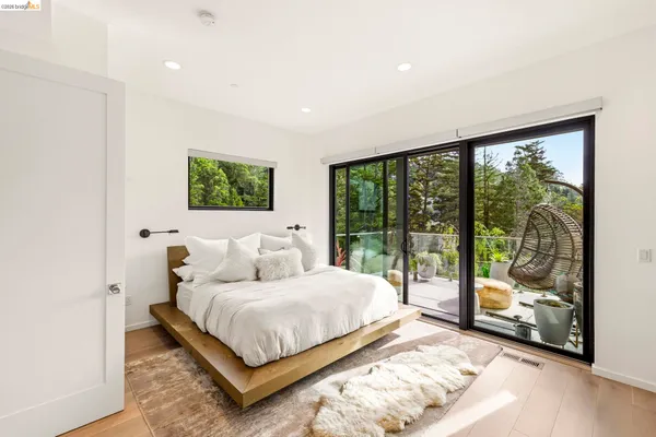 a bedroom with furniture and a large window
