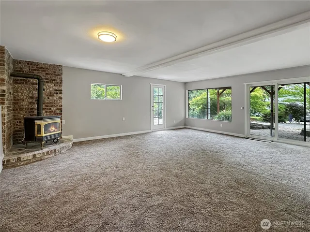an empty room with bookshelf and a window