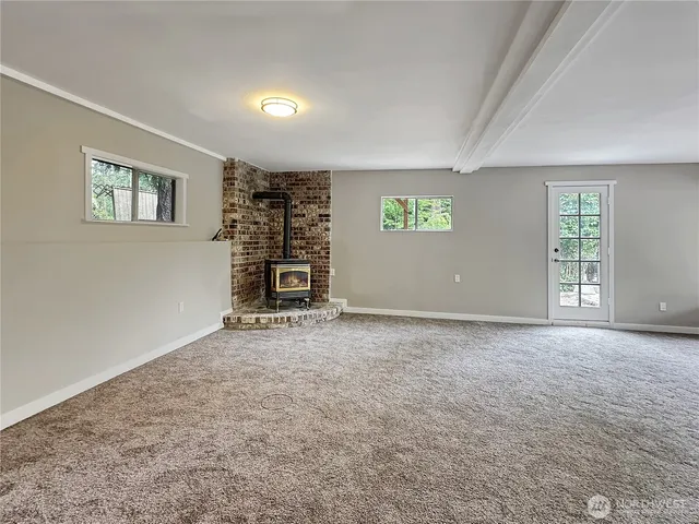 a terrace of a house with table and chairs under an umbrella