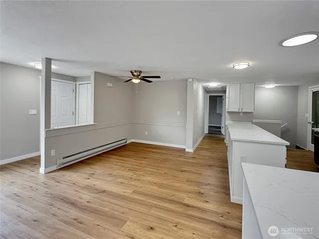 a view of empty room with wooden floor