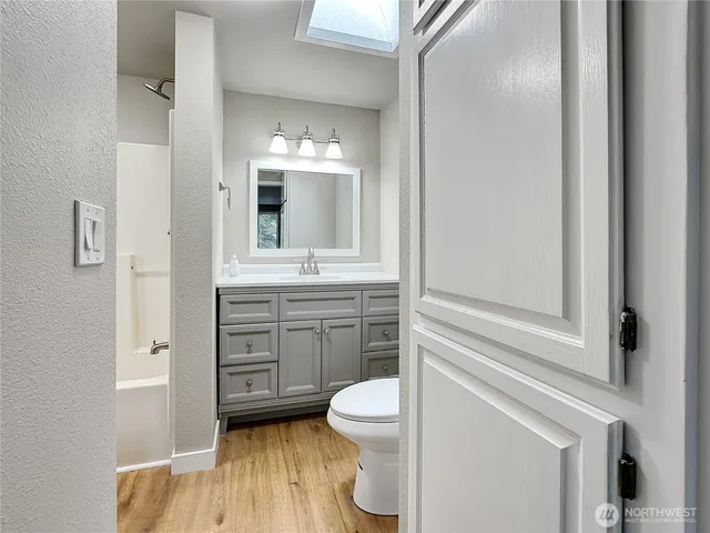 a bathroom with a toilet a sink and a mirror