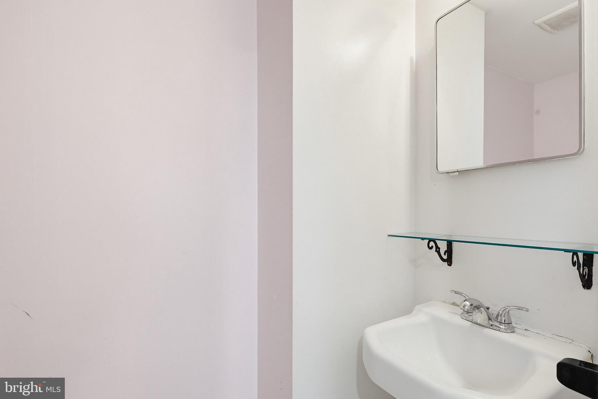 9717 Hedin Drive Silver Spring, MD 20903 - Photo 14 of 36 a bathroom with a sink and a mirror