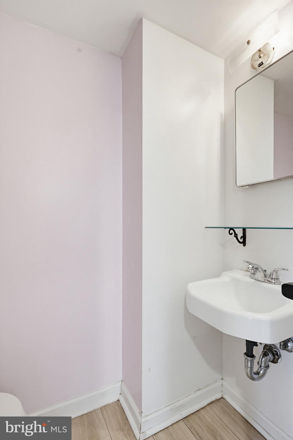 9717 Hedin Drive Silver Spring, MD 20903 - Photo 15 of 36 a bathroom with a sink and a mirror