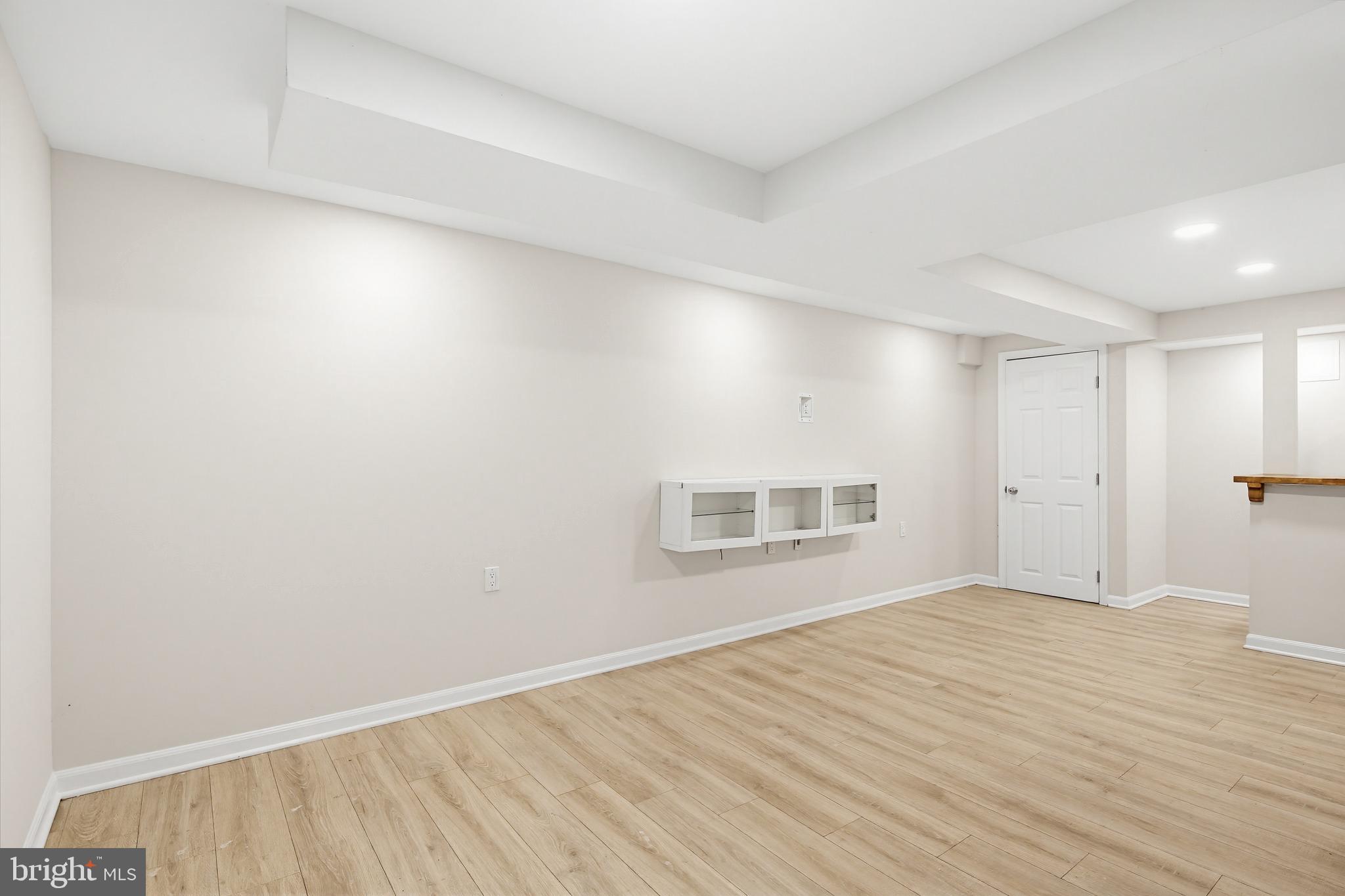 9717 Hedin Drive Silver Spring, MD 20903 - Photo 16 of 36 a view of an empty room with wooden floor and a window