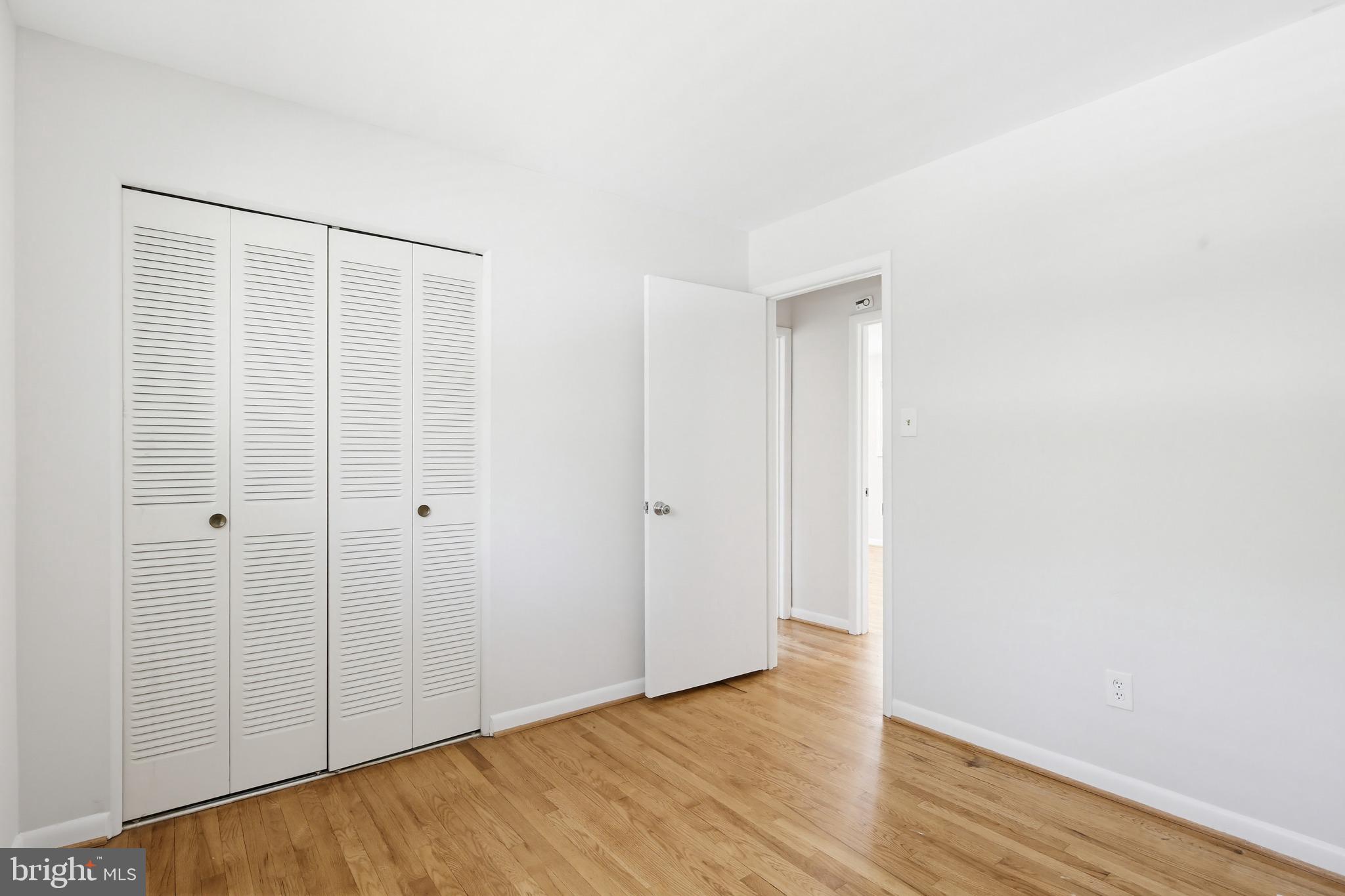 9717 Hedin Drive Silver Spring, MD 20903 - Photo 22 of 36 a view of an empty room with wooden floor