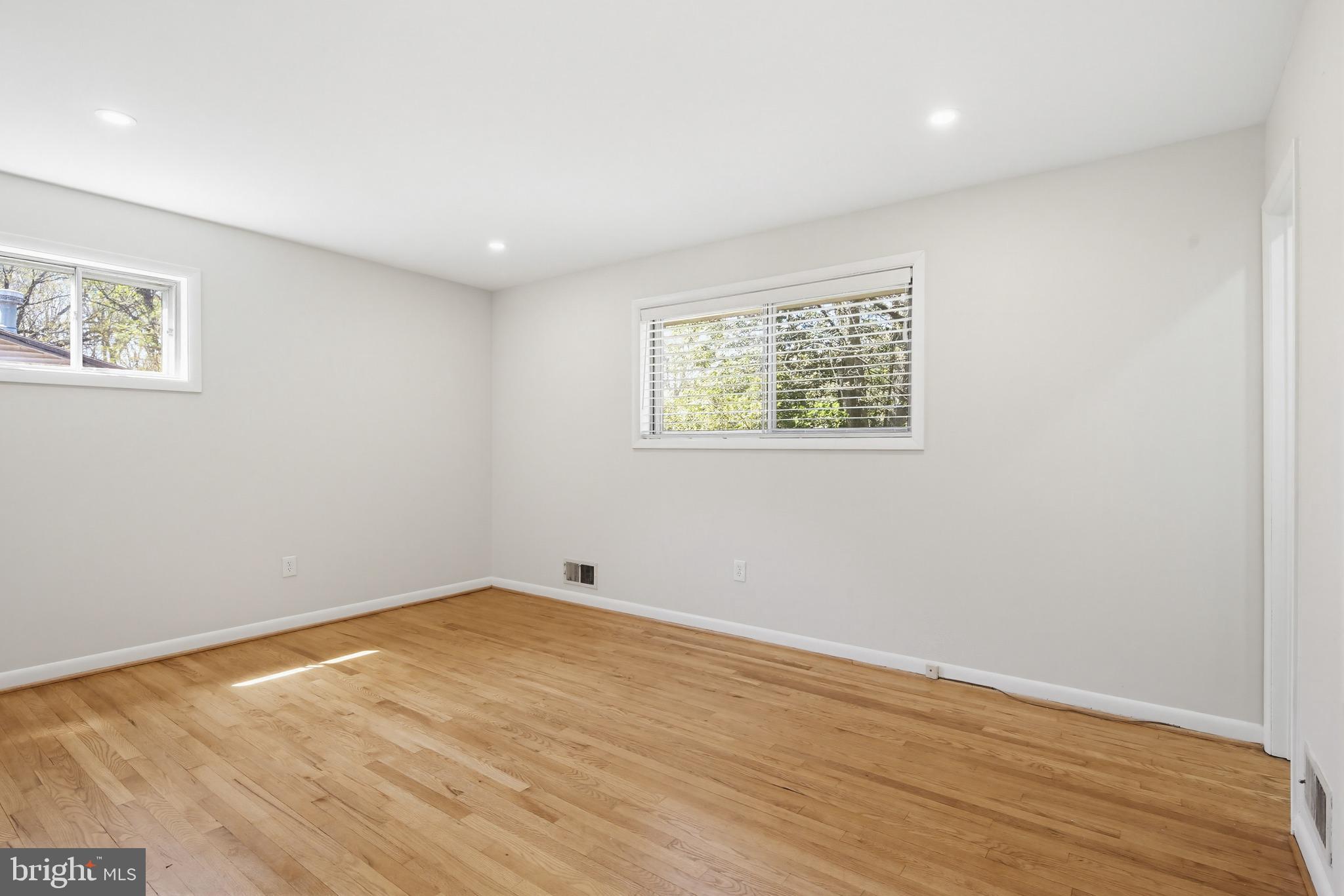 9717 Hedin Drive Silver Spring, MD 20903 - Photo 25 of 36 an empty room with wooden floor and windows