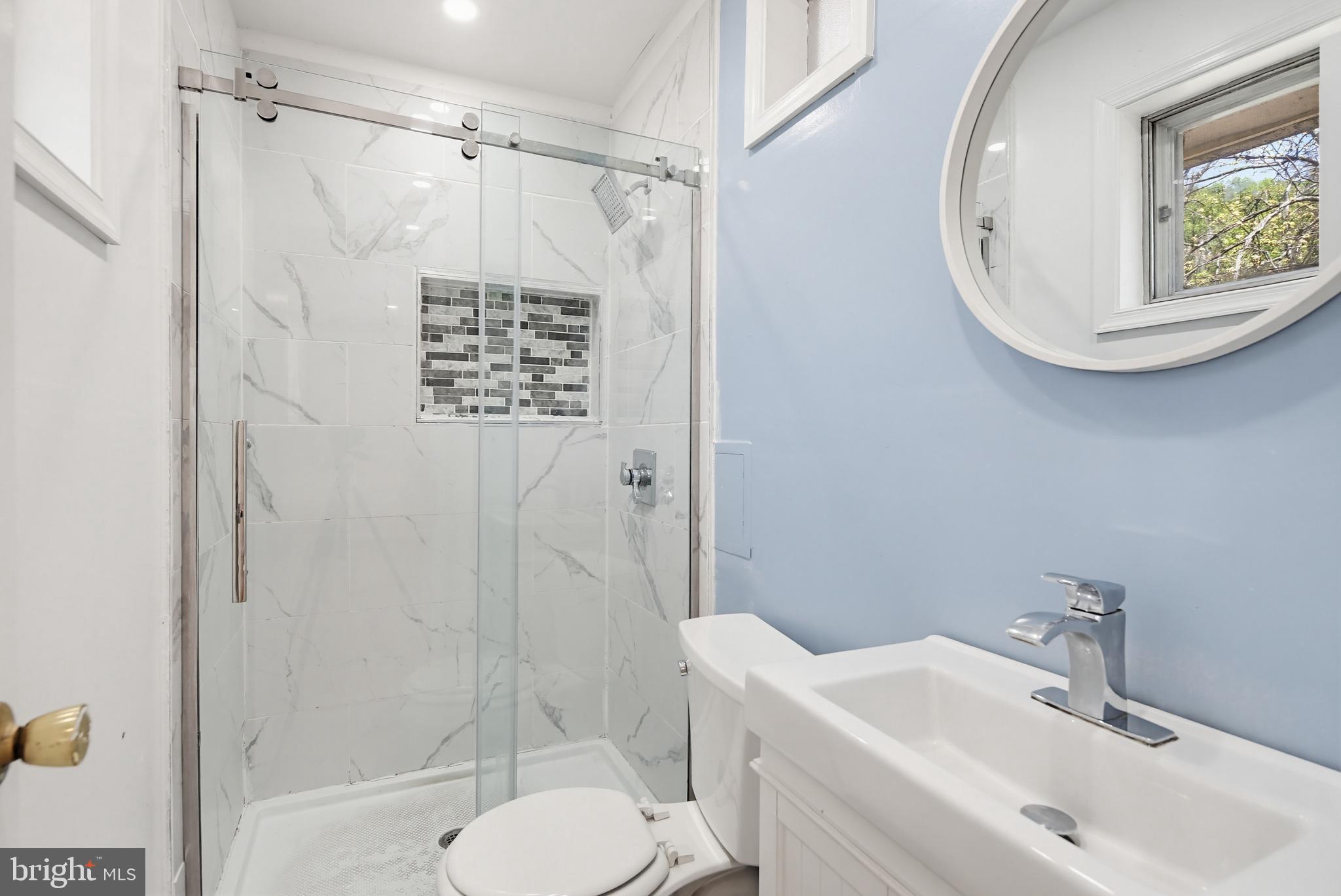 9717 Hedin Drive Silver Spring, MD 20903 - Photo 28 of 36 a bathroom with a sink toilet and shower