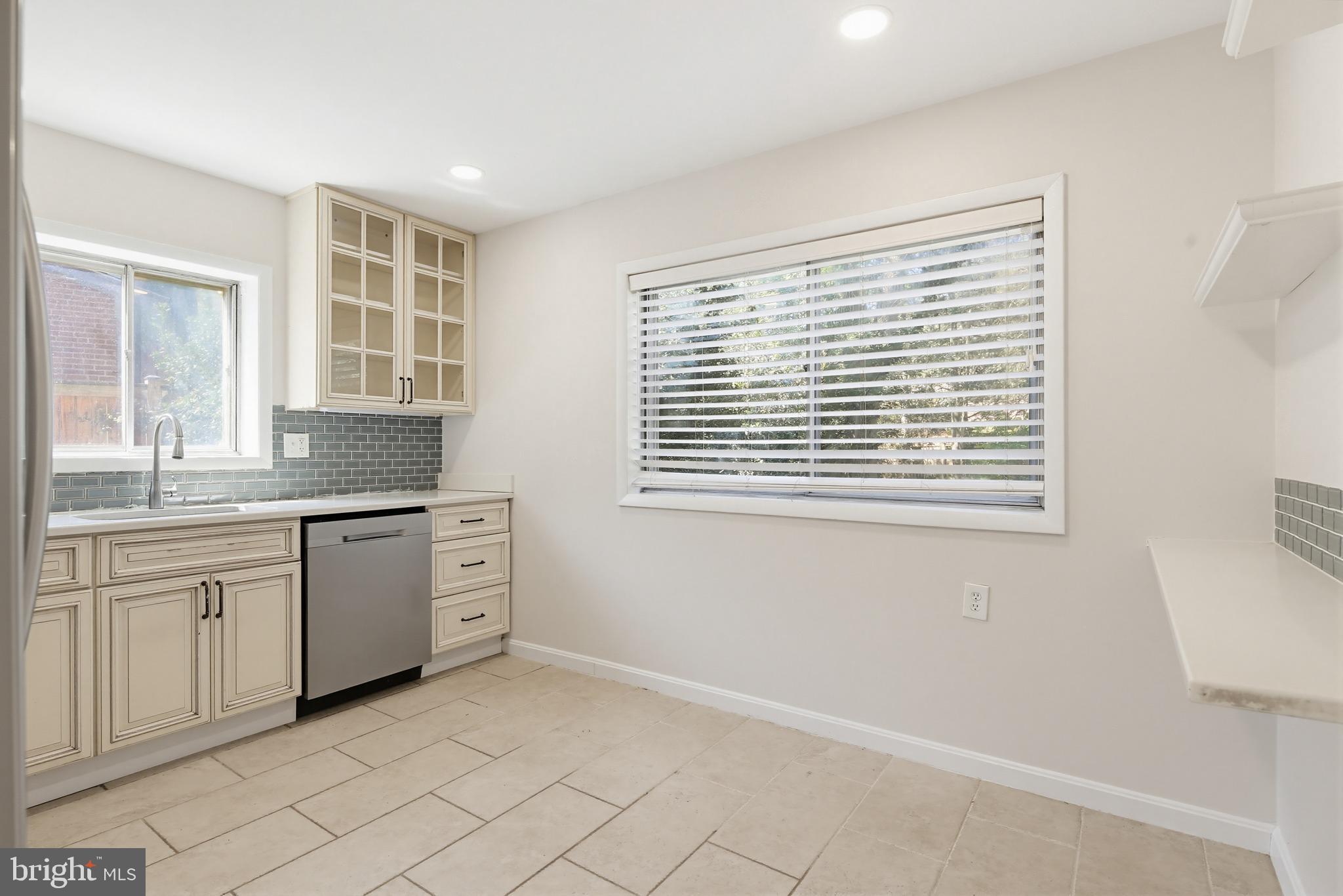 9717 Hedin Drive Silver Spring, MD 20903 - Photo 5 of 36 a kitchen with granite countertop cabinets and window